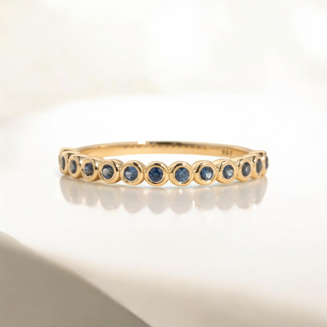 Round Blue Sapphire Bezel Half Eternity Ring