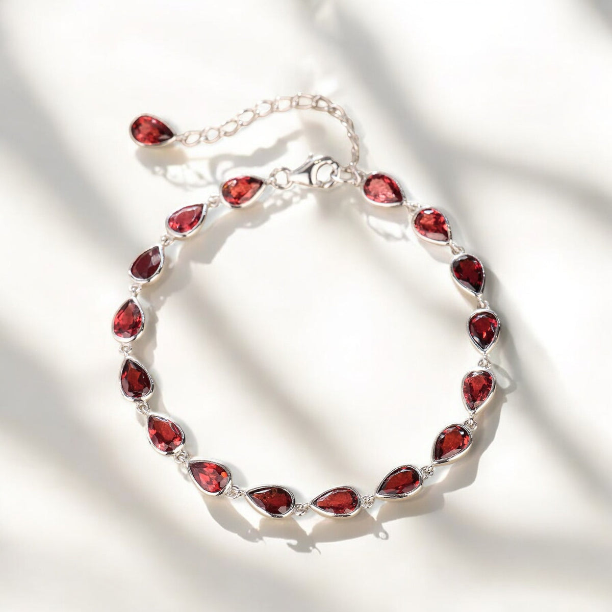 Silver Pear-Cut Garnet Tennis Bracelet - GEMPARA